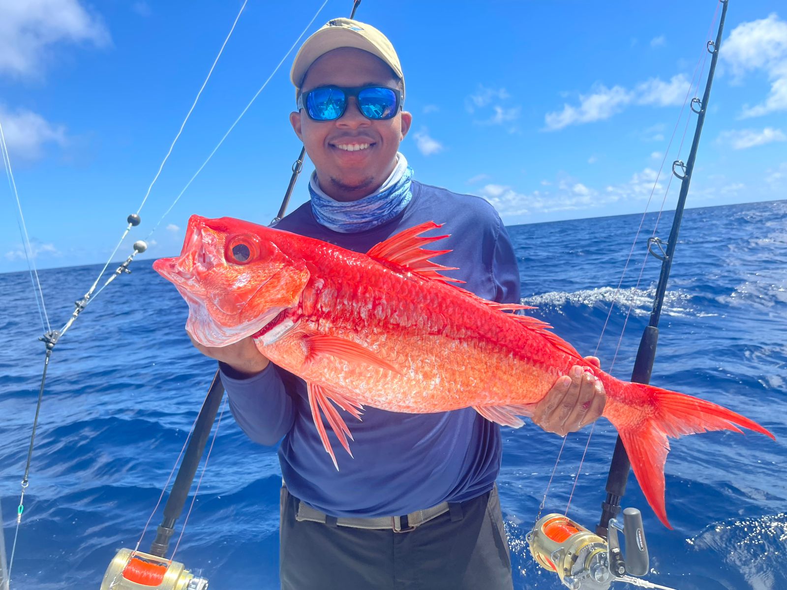 Close-up of a vibrant red reef squirrelfish with large eyes swimming near coral underwater
