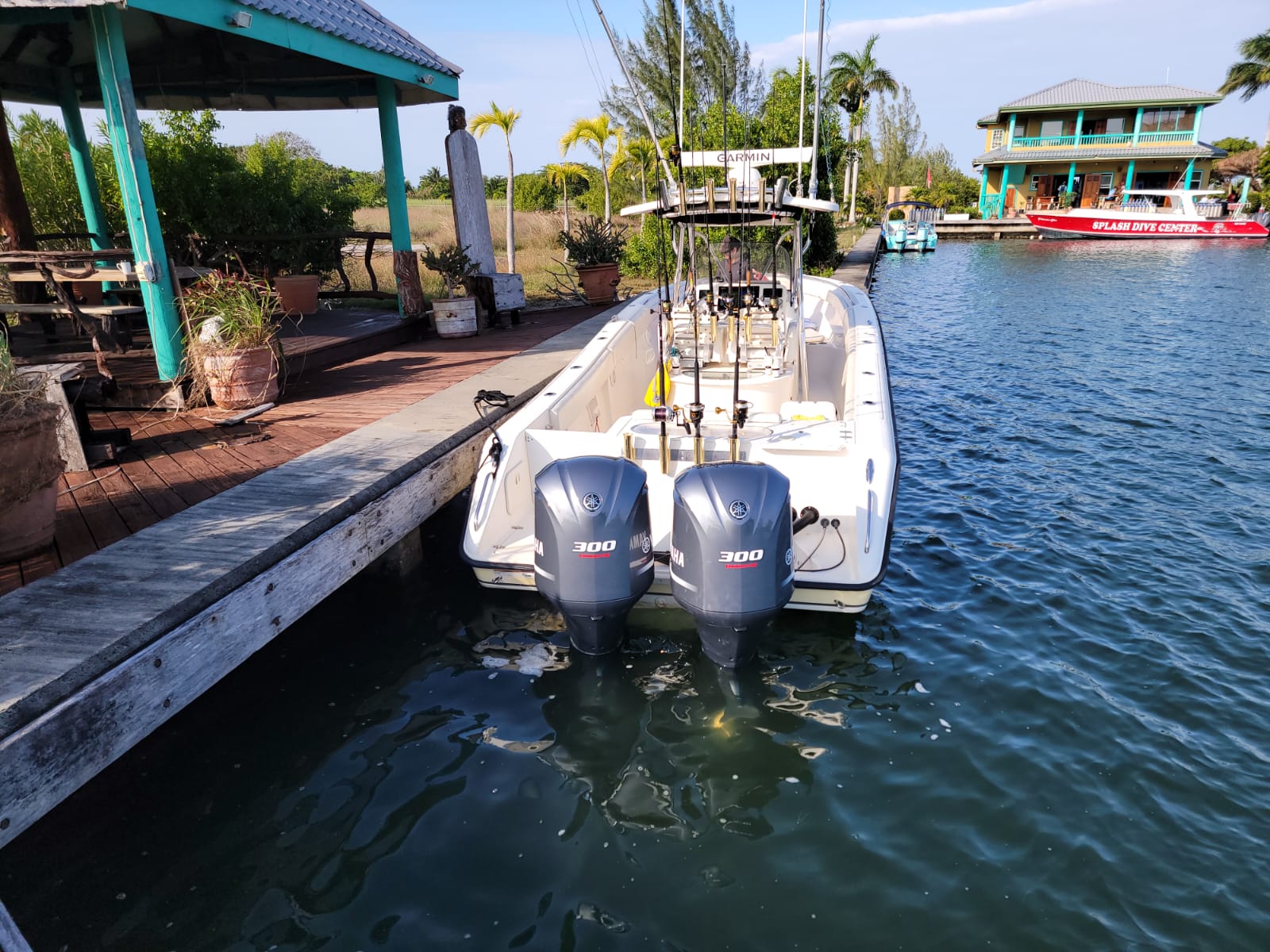 Fishing boat from Splash Dive Center docked on calm water under clear sky